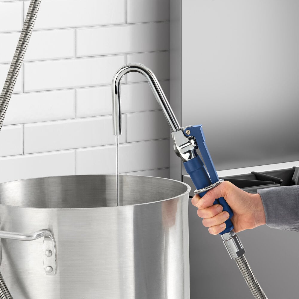 A Waterloo pot and glass filler assembly being used to fill a large metal pot with water.